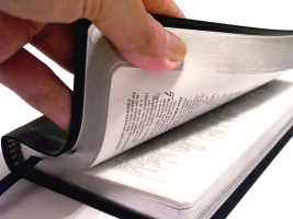 Picture of hand opening Bible